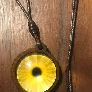 Wood pendant with yellow design and brown wax cord necklace